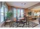 Bright dining area with wooden table and chairs, and large windows at 20377 W Terrace Ln, Buckeye, AZ 85396