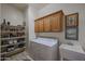 Laundry room with washer, dryer, cabinets and shelving for storage at 20377 W Terrace Ln, Buckeye, AZ 85396