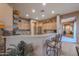 Kitchen boasts granite countertops, light wood cabinets, and breakfast bar at 20377 W Terrace Ln, Buckeye, AZ 85396