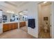 Bright bathroom with double sinks, a large mirror, and a separate toilet area at 20377 W Terrace Ln, Buckeye, AZ 85396