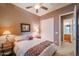 Bright bedroom with a double bed, access to a bathroom, and ceiling fan at 20377 W Terrace Ln, Buckeye, AZ 85396