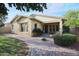 Landscaped backyard with a brick patio, lush landscaping and a covered seating area at 20377 W Terrace Ln, Buckeye, AZ 85396