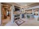 Living area with a stone fireplace and built-in shelving at 20377 W Terrace Ln, Buckeye, AZ 85396