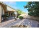 Charming backyard with a brick patio, lush landscaping and a covered seating area at 20377 W Terrace Ln, Buckeye, AZ 85396
