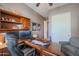 Home office features built-in wooden desk and cabinets, comfortable seating at 20377 W Terrace Ln, Buckeye, AZ 85396