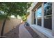 Landscaped side yard with a brick pathway, offering privacy and curb appeal at 20377 W Terrace Ln, Buckeye, AZ 85396
