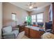 Home office with a large desk, comfortable chair, and ample natural light at 20377 W Terrace Ln, Buckeye, AZ 85396