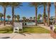 Community pool with surrounding lounge chairs and palm trees at 20377 W Terrace Ln, Buckeye, AZ 85396