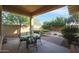 Spacious covered patio with a glass-top table, chairs, and chaise lounge at 20377 W Terrace Ln, Buckeye, AZ 85396