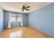 Simple bedroom with light walls and wood-look floors at 10418 N 97Th Dr # B, Peoria, AZ 85345