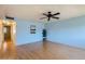 Spacious living room featuring light blue walls and ceiling fan at 10418 N 97Th Dr # B, Peoria, AZ 85345