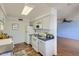 Galley-style kitchen with white cabinets and tiled floor at 10418 N 97Th Dr # B, Peoria, AZ 85345