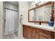 Bathroom with wood vanity, large mirror, and shower at 3248 S Golden Barrel Ct, Gold Canyon, AZ 85118