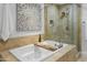 Spa-like bathroom featuring a soaking tub and walk-in shower at 7175 E Camelback Rd # 202, Scottsdale, AZ 85251