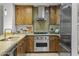 Modern kitchen with stainless steel appliances and wood cabinets at 7175 E Camelback Rd # 202, Scottsdale, AZ 85251
