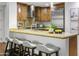 Kitchen boasts granite countertops, stainless steel appliances, and custom wood cabinetry at 7175 E Camelback Rd # 202, Scottsdale, AZ 85251