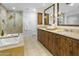 Elegant bathroom with double vanity, soaking tub, and walk-in shower at 7175 E Camelback Rd # 202, Scottsdale, AZ 85251