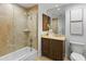 Spa-like bathroom with a soaking tub, glass shower, and wood vanity at 7175 E Camelback Rd # 202, Scottsdale, AZ 85251