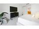 Primary bedroom with TV, plush bedding, and ensuite bathroom at 7175 E Camelback Rd # 202, Scottsdale, AZ 85251
