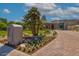 Landscaped front yard with flowers and a brick driveway at 5455 E Berneil Dr, Paradise Valley, AZ 85253