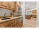 Butler's pantry with granite countertops, wood cabinets, and a built-in microwave at 5455 E Berneil Dr, Paradise Valley, AZ 85253