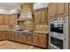 Well-equipped kitchen with stainless steel appliances and wood cabinetry at 5455 E Berneil Dr, Paradise Valley, AZ 85253