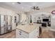 Open concept kitchen with large island, granite counters, and view into Gathering room at 22006 E Alyssa Rd, Queen Creek, AZ 85142