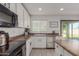 Kitchen with stainless steel appliances, white cabinets, and access to backyard at 794 E Christopher St, San Tan Valley, AZ 85140