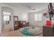 Cozy bedroom with a sitting area, large window, and plush rug at 794 E Christopher St, San Tan Valley, AZ 85140