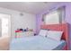 Cozy bedroom with pink headboard, dresser, and window coverings at 794 E Christopher St, San Tan Valley, AZ 85140