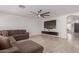 Living room features a sectional sofa and mounted TV at 794 E Christopher St, San Tan Valley, AZ 85140