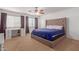 Main bedroom with large bed, dresser, and window coverings at 794 E Christopher St, San Tan Valley, AZ 85140