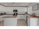 Bright eat-in kitchen with island, stainless steel appliances, and white shaker cabinets at 794 E Christopher St, San Tan Valley, AZ 85140