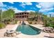 Luxury home with a stunning pool, waterfall feature, and mountain views at 40740 N Longhorn Dr, Scottsdale, AZ 85262