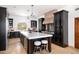 Modern kitchen with dark cabinetry, a large island, and stainless steel appliances at 40740 N Longhorn Dr, Scottsdale, AZ 85262