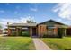 Brick house with green awnings and manicured lawn at 3329 N 17Th Dr, Phoenix, AZ 85015