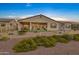 Backyard view of house showcasing patio and landscaping at 41912 W Cactus Flower Dr, Maricopa, AZ 85138