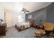 Cozy bedroom with wood bed frame and accent chair at 42331 W Somerset Dr, Maricopa, AZ 85138