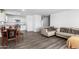 Open living room and kitchen with grey couch and wood flooring at 14852 S Diablo Rd, Arizona City, AZ 85123