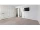 Bright bedroom featuring carpet and a wall-mounted TV at 14852 S Diablo Rd, Arizona City, AZ 85123