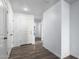 Bright hallway with wood flooring and interior doors at 14852 S Diablo Rd, Arizona City, AZ 85123