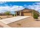 Tan single-story house with two-car garage and desert landscaping at 14852 S Diablo Rd, Arizona City, AZ 85123