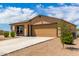 Tan single-story house with two-car garage and desert landscaping at 14852 S Diablo Rd, Arizona City, AZ 85123