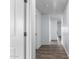 Clean hallway with light walls and wood-look flooring at 14852 S Diablo Rd, Arizona City, AZ 85123