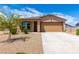Newly built home with a driveway and small front yard at 14852 S Diablo Rd, Arizona City, AZ 85123