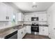 Modern kitchen with white cabinets and granite countertops at 14852 S Diablo Rd, Arizona City, AZ 85123