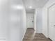 Clean and bright hallway with wood flooring and doors at 14852 S Diablo Rd, Arizona City, AZ 85123