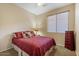 Charming bedroom with a plush bed and red bedding at 43154 N Outer Banks Dr, Anthem, AZ 85086