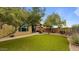 Landscaped backyard with grassy area and mature trees at 43154 N Outer Banks Dr, Anthem, AZ 85086