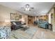 Open living room with tiled floors, ceiling fan, and views to kitchen at 43154 N Outer Banks Dr, Anthem, AZ 85086